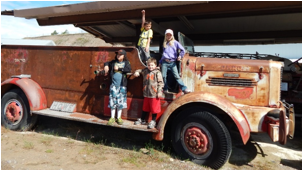 Description: A truck is parked in front of a building  Description automatically generated